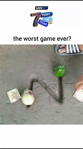 tonnyticks on Instagram: "The post showcases a 14-second video of a rigged street betting game in an urban setting, where players slide onions, green peppers, and cash bets along a zigzag metal wire track without knocking items over, but the setup guarantees the first mover loses. User replies identify it as a classic scam akin to the shell game, with one dubbing it "Somali chess" for its illogical rules and deliberate resets that prolong play while favoring the operator. Posted on February 1, 2