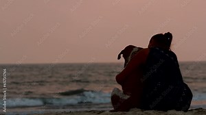 woman hugs her dog at sunset Stock Video