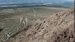 Drone Flying Over Desert Mountain Revealing Arid Desolate Desert Wilderness Valley (Ciudad Sagrada de Quilmes)