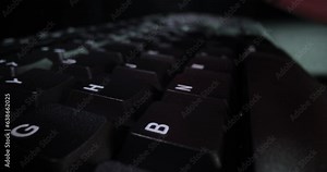 Computer kayboard typing closeup in the dark