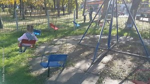 Happy little girl enjoying a ride on the merry-go-round. Cute toddler kid having fun at funfair. Family with kids spending day in amusement park