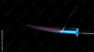 Butane gas burner flame burning from nozzle against black background. Welding tool with burner flame. Blue and Orange Flame from a butane blow torch. Closeup of butane burner.