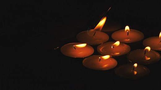 Lighting candles in the dark - Free Stock Video