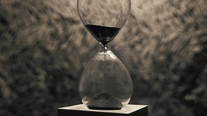 A mesmerizing shot of a magnetic hourglass as iron filings flow down, creating unique patterns