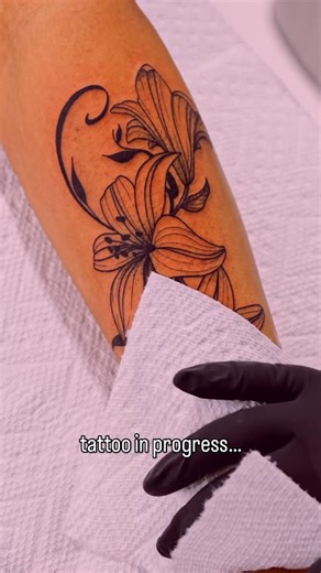 Live By The Sword Tattoo on Instagram: "Tattoo moments like this are what we’re here for 💐 A fine line lily tattoo coming together with steady hands, intentional placement, and details that reward a closer look. This kind of tattoo is built to age well and carry meaning long after the session ends ✨ Tattooed by Syd @sydney.tattoos at our Union Square location 📍 Soho, Union Square, and Williamsburg 11AM-9PM 7 DAYS A/W…🕘 WALK-INZ OR BOOK ONLINE… 📕 TATTOOS & PIERCINGS, NO ATTITUDE, NO MISERABLE