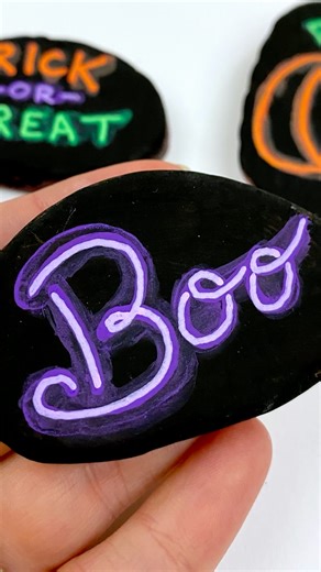 This one is about the layers.... these are water-based paint pens and I'm using water on my brush (very little) Comment shop if you want to check out the paint pens we like!! In this tutorial I am using Posca for the larger pen and Artistro extra fine tips for the lighter color. #letteringtutorial #neonletters #rockpainting #halloweencrafts | Rock Painting 101