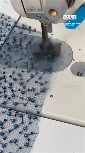High-speed hammer beading technique using a specialized sewing machine attachment to impact beads onto mesh or tulle fabric, creating rich decorative textures without thread, ideal for couture and fashion embellishment. 🎥: sewing_tutorial_and_tools / IG | Interesting Engineering