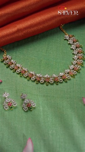 Dive into the brilliance of GRT Silver with this matching necklace and earring set. Every curve is thoughtfully detailed with layered floral elements with shimmering stones. Designed to make a lasting impression, this set balances grace and glamour effortlessly. [GRT Jewellers, Silver Necklace, Floral Design,Sparkling Silver, Elegant Jewellery, Statement Necklace, Intricate Work, Festive Wear, GRT Silver Jewellery] | GRT Jewellers