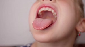 Girl Sticking Tongue Out in Close Up