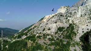 View of the marble quarries on the peaks of Apuan Alps from ancient village Colonnata, located in the province of Massa-Carrara in Tuscany, Italy