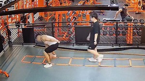 Lazy gymgoer hilariously fakes workout behind energetic trainer's back