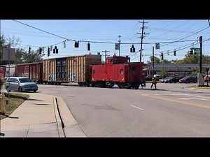 Strangest Railroad Crossing Ever! Caboose Leads Train Across, Conductor Flags Traffic