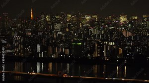 TOKYO, JAPAN : Aerial high angle view of CITYSCAPE of TOKYO at night time. View of busy central downtown area. Japanese urban metropolis and nightlife concept. Wide time lapse tracking shot.