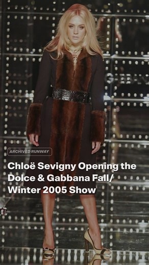 Archived Runway on Instagram: "Dolce & Gabbana’s Fall/Winter 2005 collection, described by the designers as “La Dolce Vita meets Swinging London,” blended minis and maxis, boxy jackets, Beatles caps, and tall furry hats that echoed Buckingham Palace guards. Chloë Sevigny opened the show in a belted fur-trimmed coat, her bouffant hair and stare channeling the 1960s Jean Shrimpton era the set design paid homage to. Already an indie-film style icon by the mid-2000s, Sevigny’s turn as runway opener