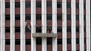 Window Cleaners Standing on Suspended Platform Cleaning Skyscraper Windows Stock Video