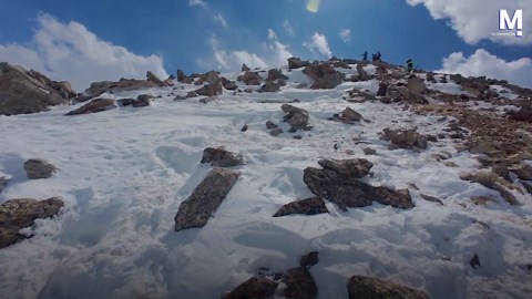 Lucky climbers narrowly escape falling rock on snowy mountain