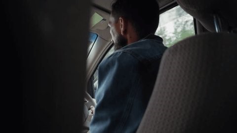 clip-3998859769-back-view-young-male-driver-beard-wearing