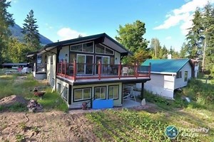 Amazing investment opportunity with gorgeous Kootenay Lake and mountain views! This 1752 square foot home boasts $150,000 in recent upgrades and renovations. Situated on a 1 acre property is the main house plus 4 separate incoming generating mobile home pads. FEATURES * 0.97 acres with stunning LAKE and MOUNTAIN views * 4 rental pads for mobile homes separate from the main home * Fantastic location within walking distance of golf course, Balfour Ferry/Marina, Dock 'n Duck Pub, Balfour Beach Inn 