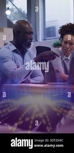 Business professionals reviewing data and charts on a tablet at a desk, collaborating on strategy and planning in a modern office. Business people concept