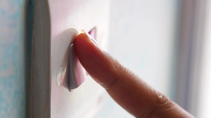 A finger turning on lighting switch