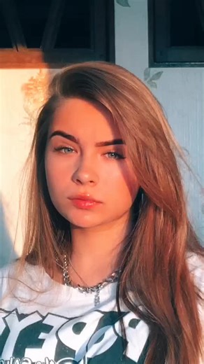 Warm Sunset Portrait with Light Brown Hair and Graphic Tee