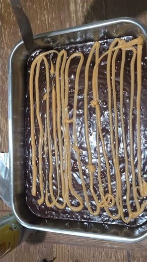 Making brownies. But mixing 2 different kinds together.