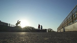 Man and woman hold hands and ride on hover board