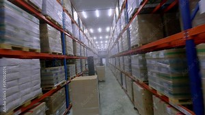 FPV drone between high multi-storey shelves in frozen food storage warehouse