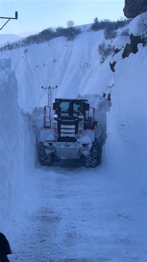 A powerful bulldozer is clearing snow that is 4 meters deep. #snow