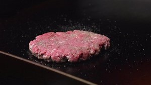 Burger flip on a flat top grill.