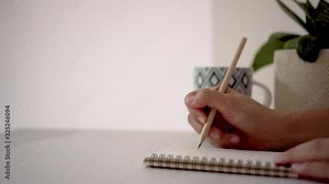 4K video of woman hand writing down in white notebook with work space beautiful nature view background.
