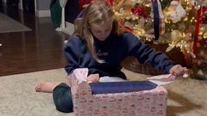 Young girl gets a hoverboard for Christmas and reacts dramatically before riding it