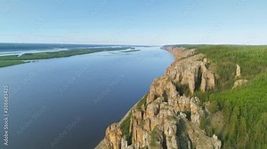 From great hight Lena pillars Yakutia vertical cliffs rock formation Lena island river delta. National park Russia. Natural monument cinematic landscape Travel landmark. Open space horizon blue sky