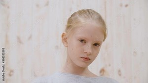 Portrait arrogant girl teenager with disgust to camera in light studio. Close up face disgusting girl teenager. Disgusting, abominable, contempt and other negative people emotions