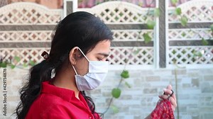 Double mask prevent infection, Young indian girl wearing two face mask to protect from new strain of coronavirus or new wave of covid-19 outbreak in india. SARS-CoV-2.
