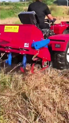 Operating tractor steadily across dry harvested farmland
