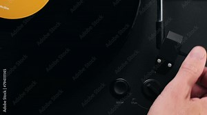 Retro Vinyl record player playing music, close-up macro shot of vintage LP disc old phonograph spinning. Retro music player at home.