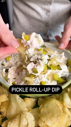 Pickle roll-ups had a glow-up! 🤩 This Pickle Roll-Up Dip is the grown-up version of your favorite childhood snack. Serve with chips, vegetables, or crackers for the perfect party appetizer! Continue reading or click the 🔗 in bio for the full recipe! Ingredients: 1 (8 ounce) package cream cheese, at room temperature 1 1/2 cups finely chopped dill pickles, plus more for garnish 3 tablespoons pickle brine from the jar 1 cup chopped smoked deli ham wavy sea salt kettle chips or sour cream and onio