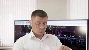 Control room with digital screens engineering system. Man engineer heating system is working learning documents and data monitors on thermal power station. Modernization of central heating system.