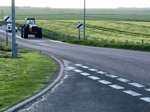Exploring a Red Tractor on a Scenic Rural Road