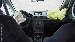 Deployed car airbags after a collision, car accident, vehicle security system after car crash. Deflated air bag