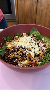 Fantastic "Longevity" summer salad Olivia uses arugula, spinach, cherry tomatoes, cucumbers, red onion, black beans, olives, walnuts, sunflower seeds, feta cheese, oregano, olive oil, lemon juice, dijon mustard, maple syrup and avocado to make a healthy salad. This original video was produced by Network Media LLC and Olivia | Olivia