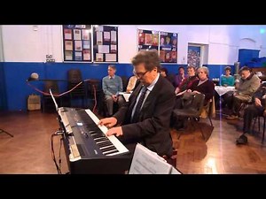 Howard Blake performing 'Walking in the Air' on piano at Downs Junior School, Brighton
