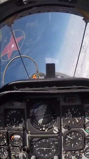 Front view of a pilot flying a US Air Force T-38 Talon while above the clouds