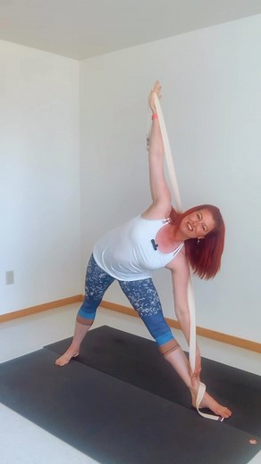 How do you know if you have proper alignment in Triangle pose? Try this simple hack using a yoga strap! Follow me for daily yoga tips for beginners! | Yoga Traveler