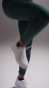 Free stock video - Vertical video close up shot of female athlete wearing tracksuit training in gym fitness class running on the spot against plain background in real time