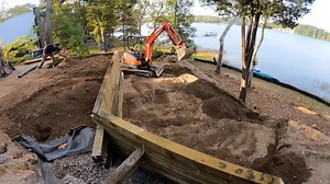 How to Build a Retaining Wall With Landscape Timbers on a Budget