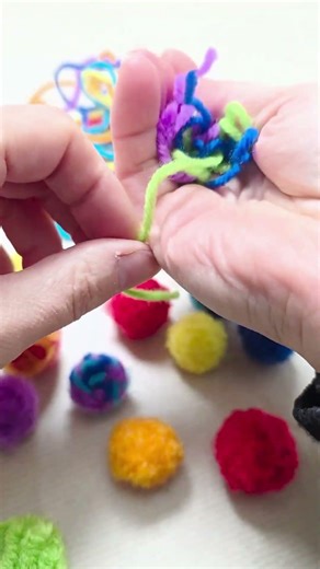 One simple tool is all you need to make these multi coloured scrap yarn pom poms