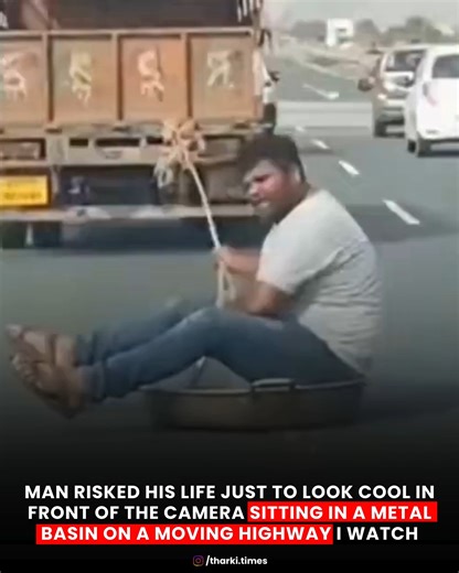 Tharki Times on Instagram: "A shocking video making rounds online shows a man putting his life at serious risk just for the camera. He is seen sitting inside a metal basin placed on a moving vehicle on a busy highway, seemingly more focused on looking “cool” than on his own safety. The clip has left viewers stunned and concerned, with many pointing out how a single slip or sudden brake could have led to a fatal accident. What may look like a stunt for attention highlights a much bigger issue — h
