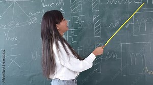 Portrait attractive of smiling Asian Teacher woman teaching student in physics classroom, Female teacher writing on blackboard, High school and back to school concept.